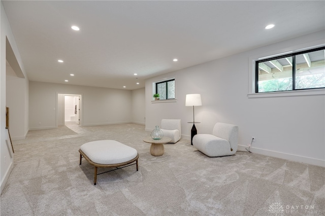 sitting room with a healthy amount of sunlight and light colored carpet