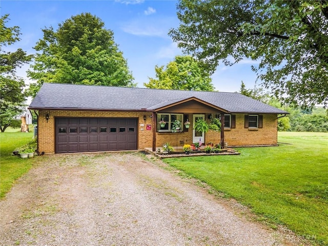 single story home with a front yard, an attached garage, brick siding, driveway, and roof with shingles
