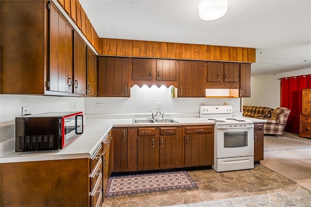 kitchen with light tile patterned floors, electric range, and sink