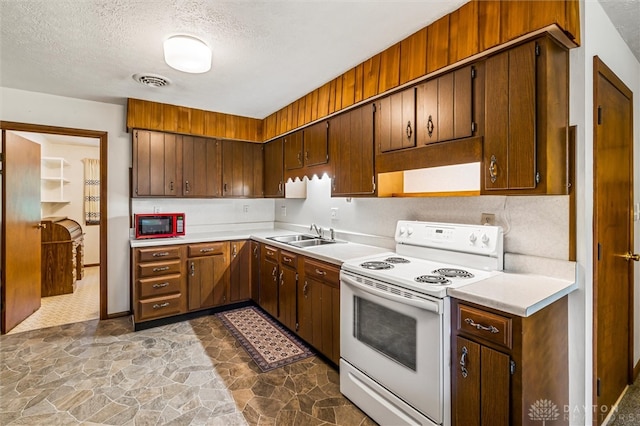 kitchen featuring tile patterned floors, electric range, sink, black microwave, and a textured ceiling