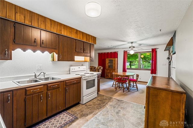 kitchen with white range with electric stovetop, ceiling fan, sink, light colored carpet, and a textured ceiling