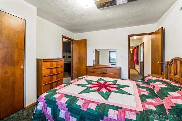 carpeted bedroom featuring a textured ceiling and a closet