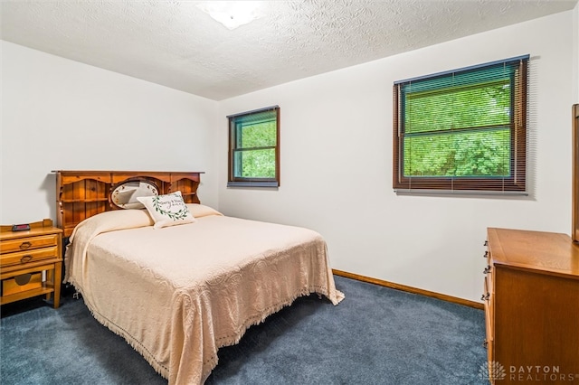 carpeted bedroom featuring a textured ceiling