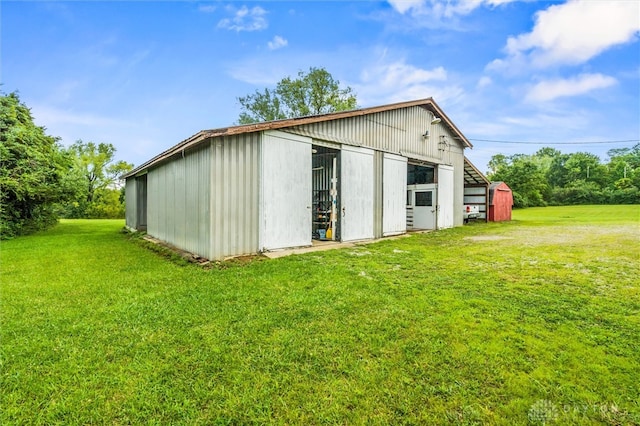 view of outdoor structure featuring a lawn