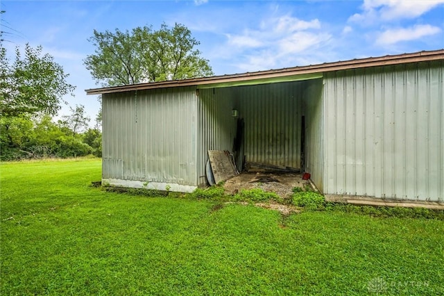 view of pole building with a yard
