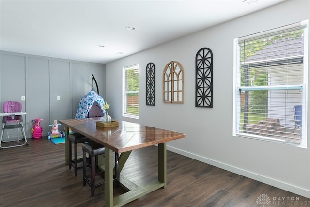 dining space featuring dark hardwood / wood-style flooring and a healthy amount of sunlight