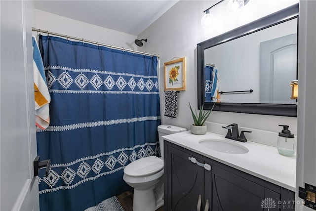 bathroom with vanity, toilet, and walk in shower