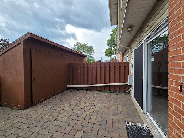 view of patio featuring a storage shed