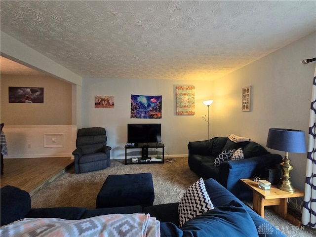 living room with carpet and a textured ceiling