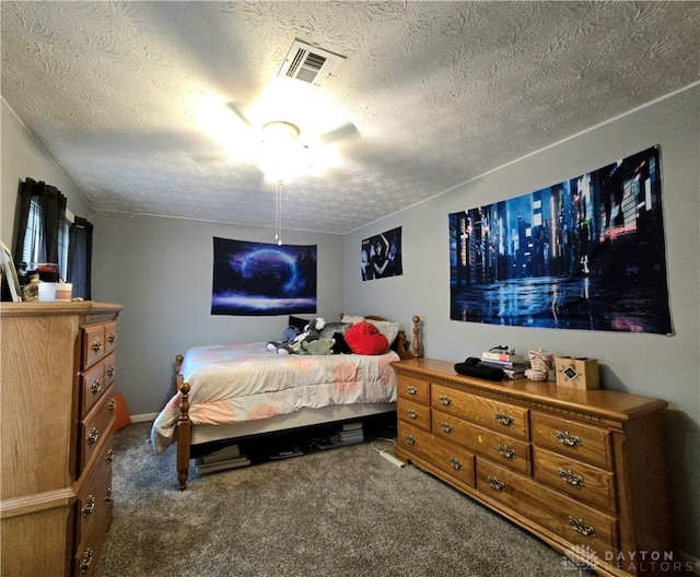 bedroom featuring carpet, ceiling fan, and a textured ceiling