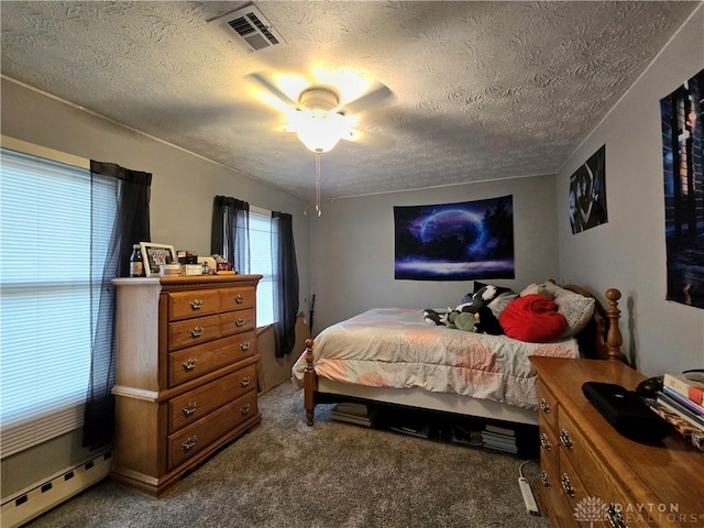 carpeted bedroom featuring a textured ceiling, ceiling fan, and a baseboard heating unit