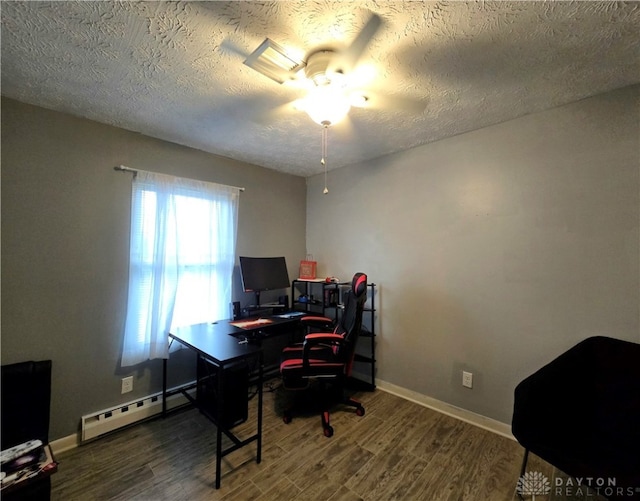 office space featuring hardwood / wood-style floors, ceiling fan, a textured ceiling, and a baseboard heating unit