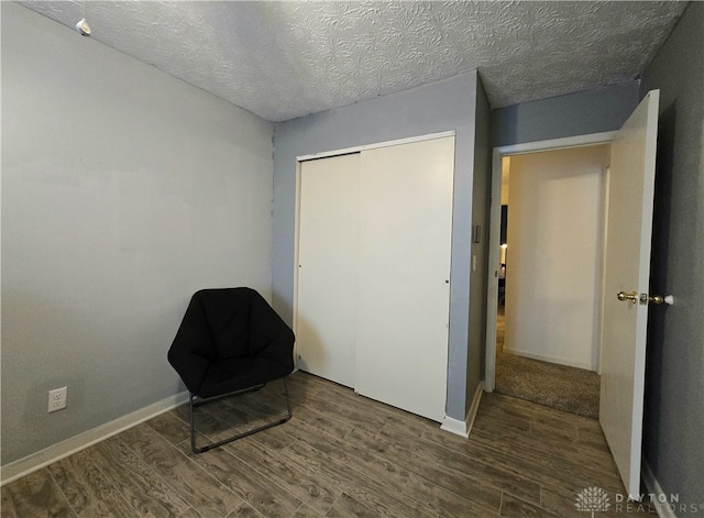 unfurnished room with dark hardwood / wood-style flooring and a textured ceiling