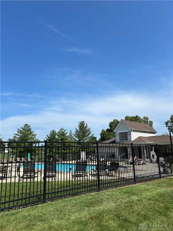 view of pool featuring a patio area and a yard