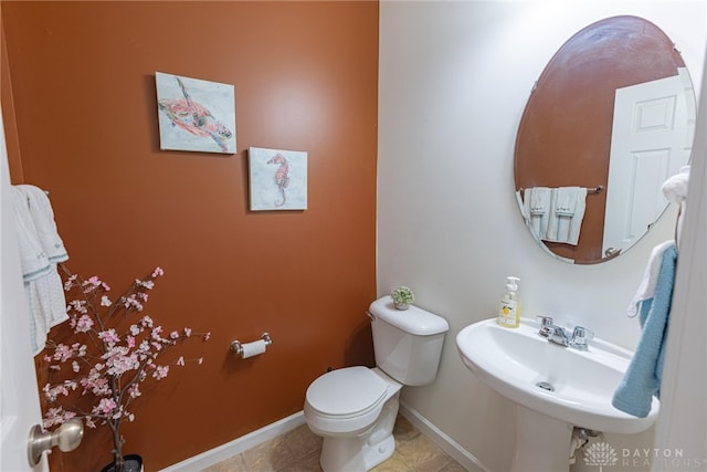 bathroom with tile patterned flooring, toilet, and sink