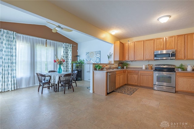 kitchen featuring stainless steel appliances, sink, light tile patterned floors, lofted ceiling, and ceiling fan