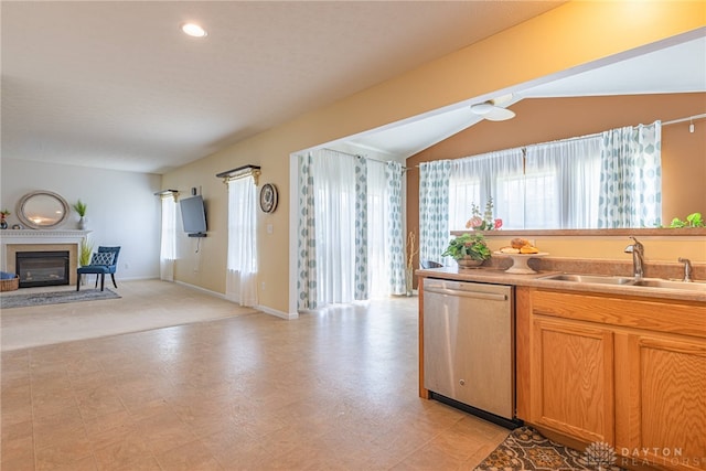 kitchen featuring light tile patterned flooring, sink, dishwasher, and lofted ceiling