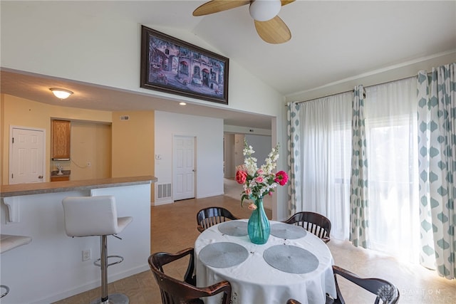 dining area with light tile patterned flooring, lofted ceiling, and ceiling fan