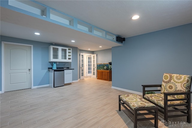 living area featuring light hardwood / wood-style flooring and french doors