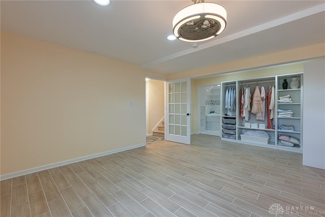 unfurnished bedroom featuring light hardwood / wood-style floors and a closet