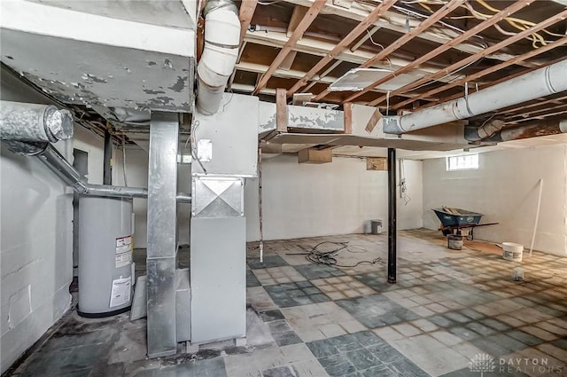 basement featuring water heater and heating unit