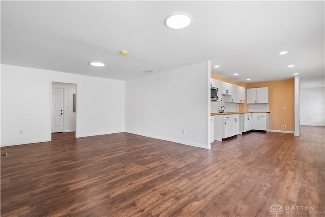 unfurnished living room featuring dark hardwood / wood-style flooring