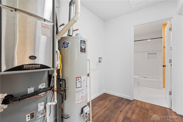 utility room featuring water heater and heating unit