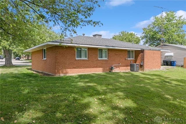 back of property featuring a yard and central AC unit