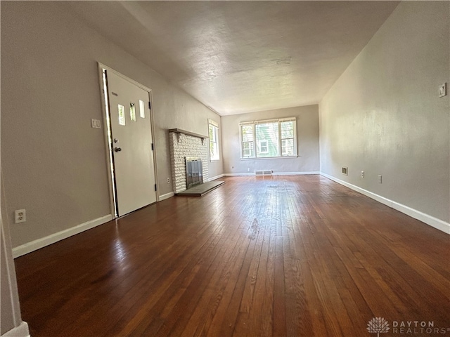 unfurnished living room with a fireplace and dark hardwood / wood-style flooring