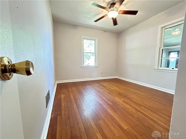 empty room featuring ceiling fan and hardwood / wood-style floors