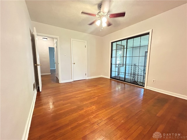 empty room featuring ceiling fan and hardwood / wood-style floors