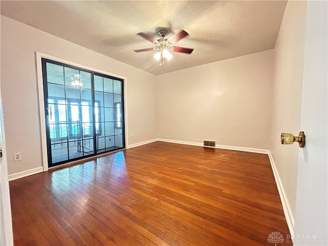 empty room featuring ceiling fan and hardwood / wood-style floors