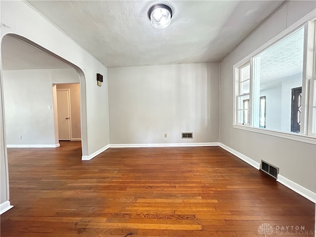 empty room with hardwood / wood-style flooring