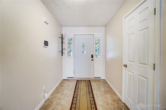 entrance foyer featuring a textured ceiling