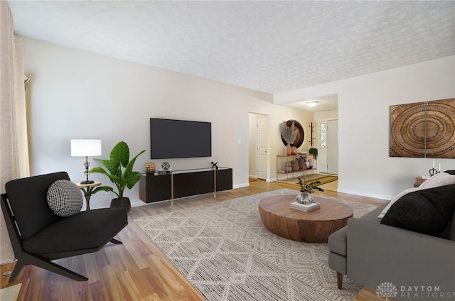 living room featuring a textured ceiling and hardwood / wood-style flooring