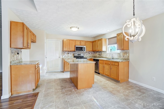 kitchen with decorative backsplash, a textured ceiling, appliances with stainless steel finishes, decorative light fixtures, and a kitchen island