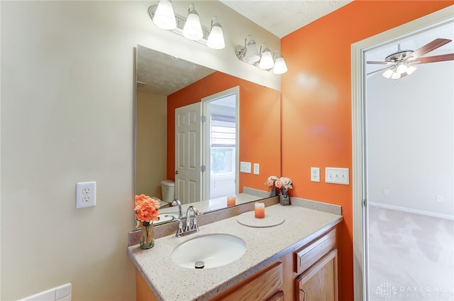 bathroom featuring ceiling fan, vanity, and toilet