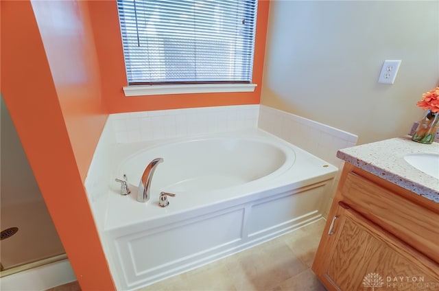 bathroom with tile patterned flooring, vanity, and a bathtub