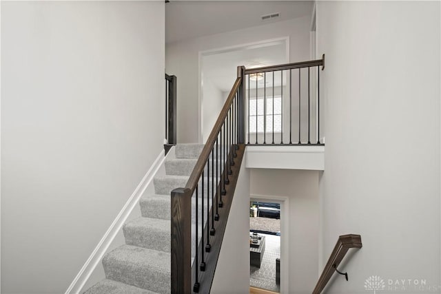 stairs featuring a towering ceiling