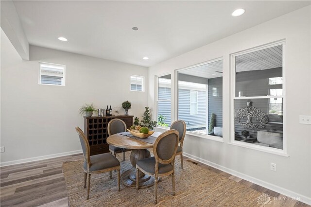 dining space featuring wood-type flooring