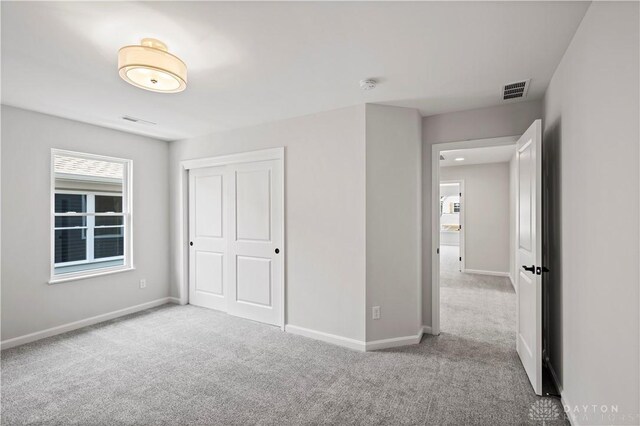 unfurnished bedroom featuring a closet and carpet floors