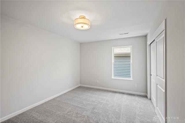 unfurnished bedroom with a closet and carpet floors