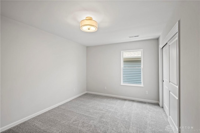 empty room with light colored carpet