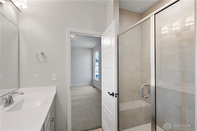 bathroom with walk in shower and vanity