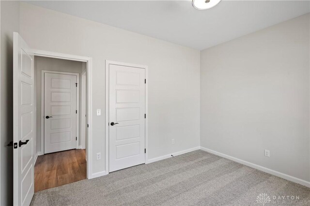 unfurnished bedroom with a closet and carpet