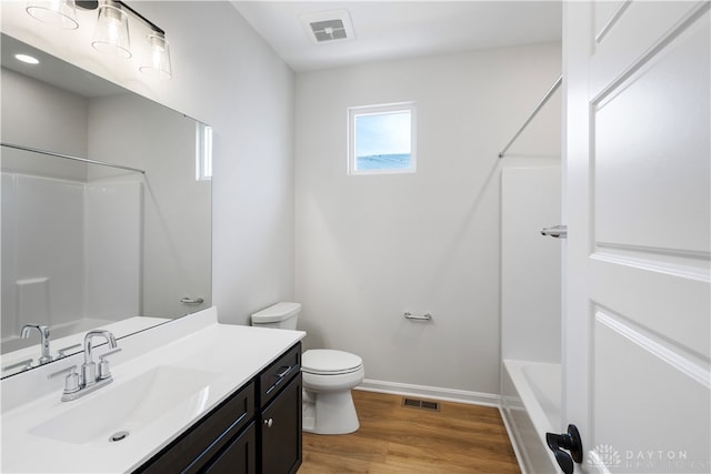 full bathroom with shower / bathtub combination, vanity, toilet, and hardwood / wood-style flooring