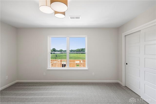 unfurnished bedroom featuring carpet flooring and a closet