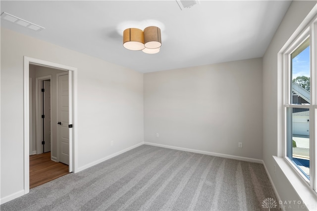 unfurnished room featuring carpet