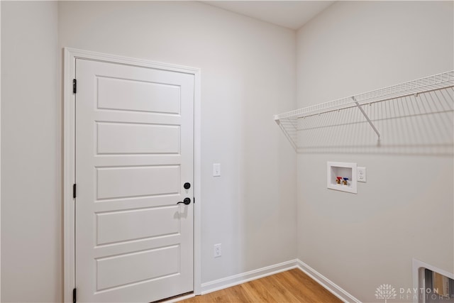 clothes washing area featuring hookup for a washing machine and light hardwood / wood-style floors