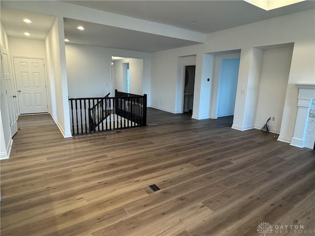 spare room with dark wood-type flooring